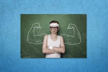 Social media asset for ClearScore. Photo of a thin man in workout clothes, standing in front of a chalkboard with biceps drawn on the board either side of him. Photo is on blue background.