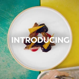 Still frame from our 'Fusion of Innovation' branded content for Infiniti. Top down view of a plate of food against a half blue and half yellow background.