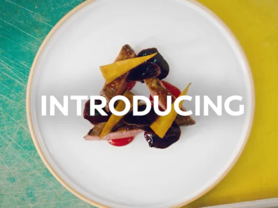 Still frame from our 'Fusion of Innovation' branded content for Infiniti. Top down view of a plate of food against a half blue and half yellow background.