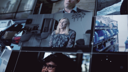 Still frame from The Pursuit launch film. Collage of different videos of scientists talking about their work. The central clip is of a blonde woman being interviewed.