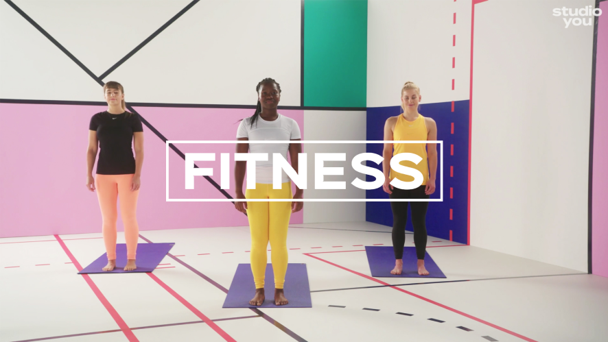 3 women in colourful workout gear stand on mats, in front of a colourful, geometric green screen background. White copy in the centre says 'FITNESS' framed by a white triangle