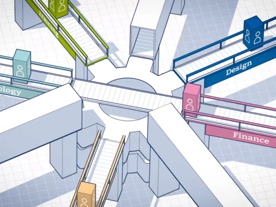 Still frame from our 'Put to Work commercial for Western Office. Animated white conveyor belts meet at a centre, which rotates to direct different coloured boxes to the right conveyor belt, representing employees being assigned to the right job sector for them.