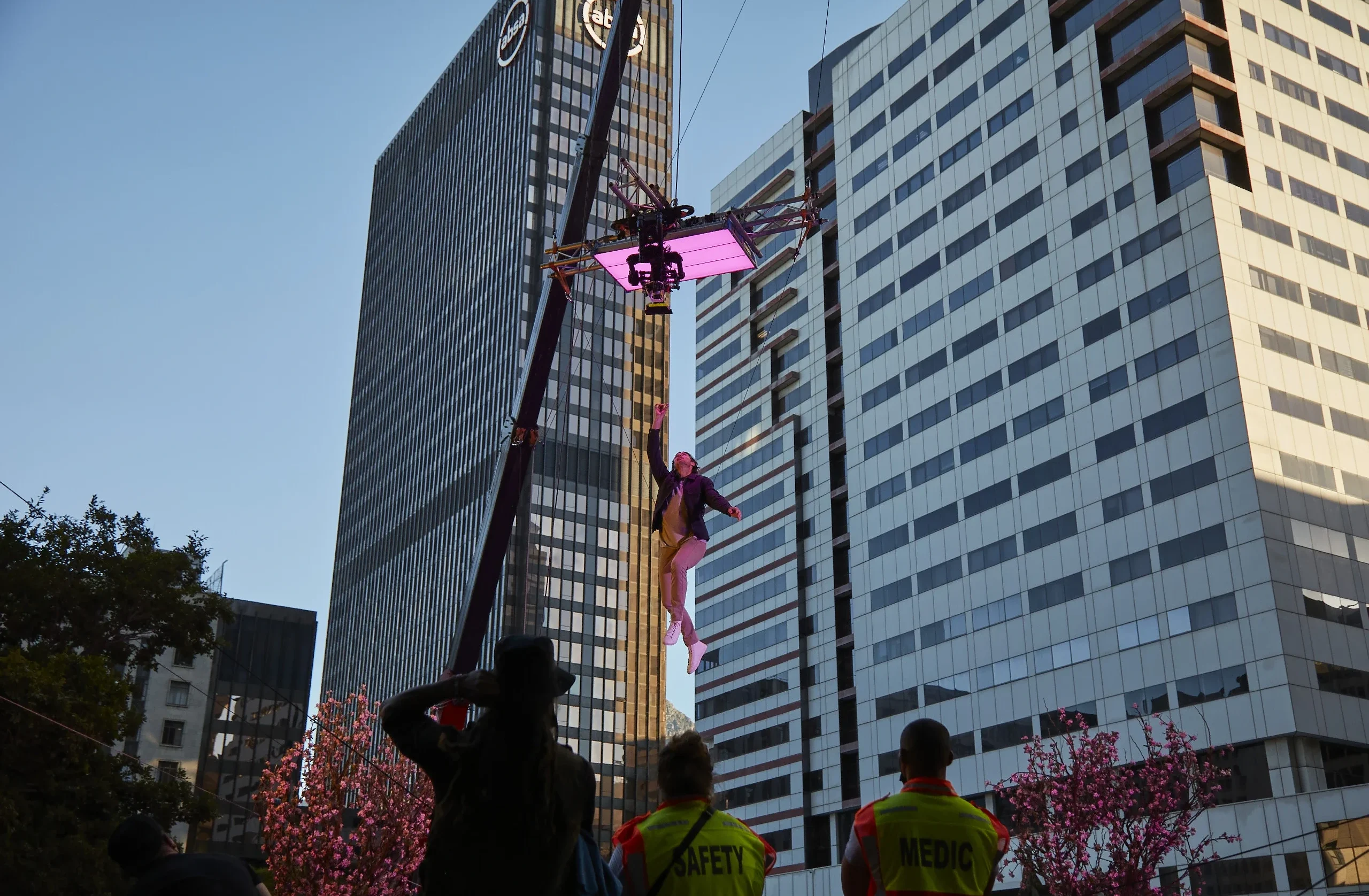 Behind the scenes image from City Index TVC filming. Actor is being lifted into the air via a crane, with a camera above him to capture the shot.