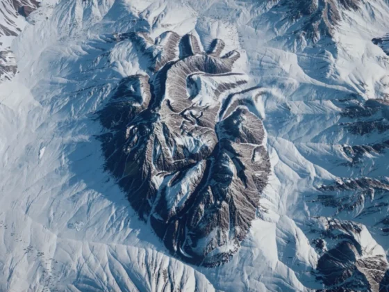 Still frame from 'Go Deeper' Launch film for SCIEX. The shape of a realistic heart is carved out of the rock face of a snowy mountain.