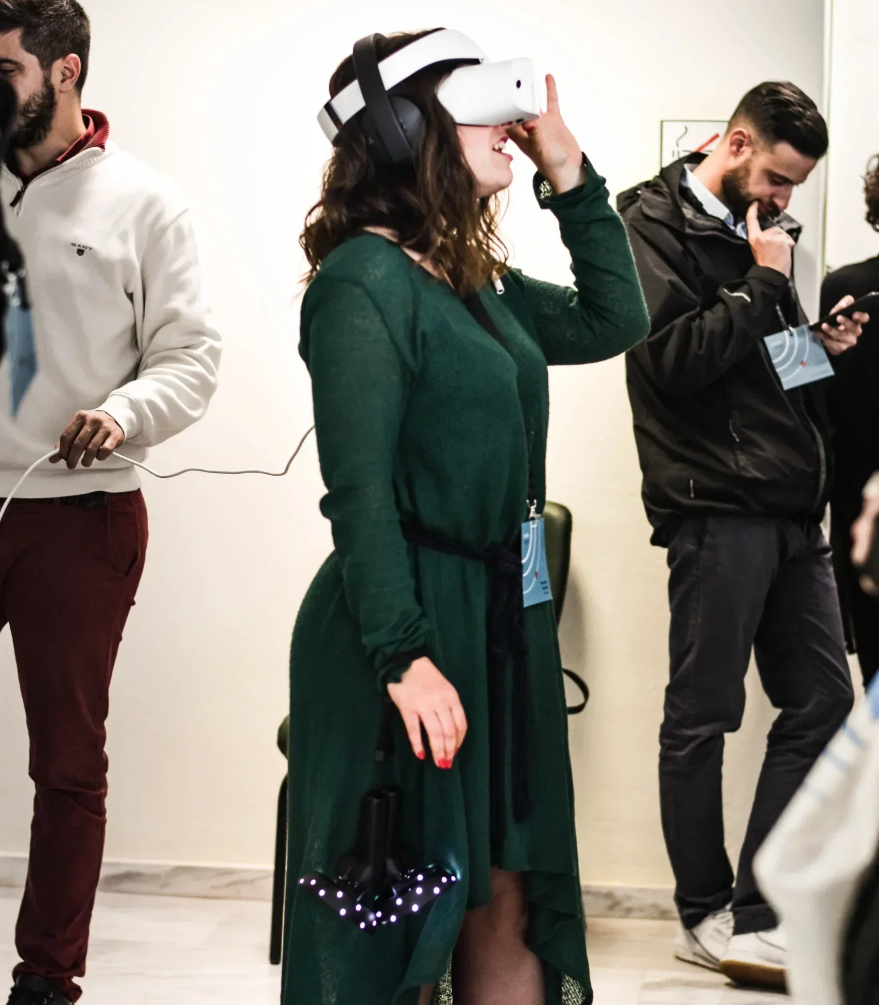 A woman at a virtual reality exhibit, exploring content through a VR headset and headphones.